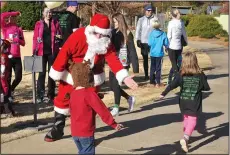  ?? File Photo ?? Santa Claus gives high fives to the kids as they cross the finish line during a previous Reindeer Fun Run at the Botanical Garden of the Ozarks. The Jingle Bell Jog 5K and Reindeer Fun Run Dec. 1 will benefit the garden.