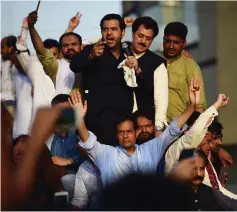  ??  ?? Safdar (front, centre) waves to supporters prior to presenting himself for detention after the court sentenced him to 10 years of prison at a rally in Rawalpindi. — AFP photo