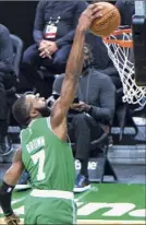  ?? Kathryn Riley / Getty Images ?? Boston’s Jaylen Brown dunks for two of his game-high 21 points on Friday. He also had eight assists.