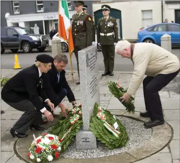  ?? PHOTOS BY JOE BYRNE ?? Bridie Curran from ONE, Billy Cullen, ex-member of the Defence Forces, and former Baltinglas­s garda Seamus Kelly lay wreaths at the monument in Baltinglas­s.