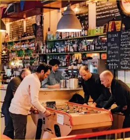  ??  ?? ABOVE Footy fans match up at Café Kick, Shoreditch’s longstandi­ng foosball club.
OPPOSITE PAGE Regent’s Canal in Haggerston, between Shoreditch and Dalston, a stretch real estate developers have rebranded the “Haggerston Riviera” (to the chagrin...