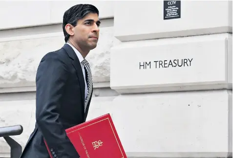  ??  ?? Rishi Sunak, the Chancellor, arrives at the Treasury yesterday after a meeting in Downing Street in advance of his Budget speech to the House of Commons today