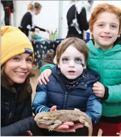  ??  ?? Loreana, Adam and Dylan Gleeson from Mallowhad a close encounter with Bruce the Bearded Dragon from Animal Roadshow.