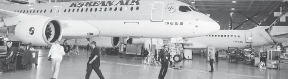  ?? RYAN REMIORZ/THE CANADIAN PRESS ?? Bombardier staff work on C Series CS300 jets at the company’s plant in Mirabel, Que. The Montreal-based firm accused the U.S. of “hypocrisy” for similarly selling aircraft below production costs, as it decided to add an 80-per-cent anti-dumping duty...