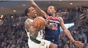  ?? JEFF HANISCH / USA TODAY SPORTS ?? Bucks guard Eric Bledsoe shoots against Wizards guard Jordan McRae during the second quarter.