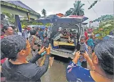  ?? Picture: ELIKI NUKUTABU ?? Mourners take photos of the hearse of the Tukini Cama during his funeral service at St Vincent DePaul Parish in Nausori yesterday.