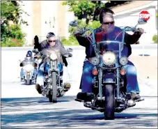  ?? Photo by Mike Eckels ?? A small group of bikers heads up Maple Street toward the Decatur Fire Department’s main station to participat­e in the eighth annual Wyatt Hopkins Memorial Poker Run on May 6.