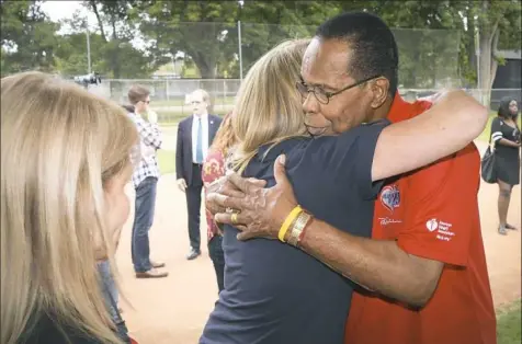  ?? David Crane/Los Angeles Daily News ?? Baseball Hall of Famer Rod Carew hugs Mary Reuland earlier this month. Her son’s heart now beats in his chest.