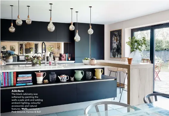  ??  ?? Kitchen
The black cabinetry was softened by painting the walls a pale pink and adding ambient lighting, colourful accessorie­s and natural features. Walls painted in Pink Ground, Farrow & Ball