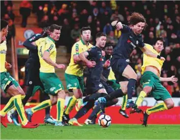  ?? Reuters ?? Chelsea’s David Luiz vies with Norwich City’s Timm Klose during the FA Cup third round match at Carrow Road in Norwich on Saturday.