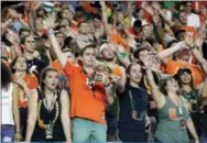  ?? LYNNE SLADKY — THE ASSOCIATED PRESS ?? Miami fans cheer during the second half of Saturday’s win over Notre Dame.