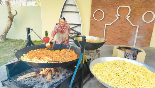  ?? VEG VILLAGE FOOD ?? More than 5 million followers tune in to a web series where they can watch Amar Kuar cook food from the simple setup in her family’s courtyard in her village in India.