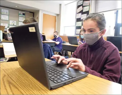  ?? H John Voorhees III / Hearst Connecticu­t Media ?? Eva Bauco, age 11, of Danbury, works during her sixth grade science class at St Joseph School.