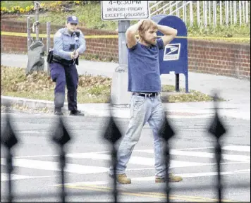  ??  ?? Edgar Maddison Welch, 28 of Salisbury, N.C., surrenders to police Sunday in Washington after firing an assault rifle inside a pizza restaurant where conspiracy theorists said a child sex-ring was being operated.