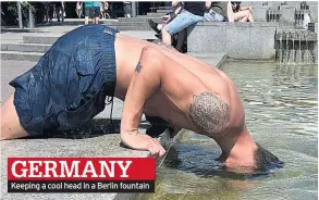  ??  ?? Keeping a cool head in a Berlin fountain GERMANY