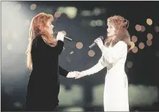  ?? ?? of his era.
Charles’ version of “I
WYNONNA JUDD (LEFT) AND HER MOTHER, NAOMI JUDD, of The Judds, perform during the halftime show at Super Bowl XXVIII in Atlanta on Jan. 30, 1994. Naomi Judd, the Kentucky-born matriarch of the Grammy-winning duo The Judds and mother of Wynonna and Ashley Judd, has died, her family announced on Saturday. She was 76.