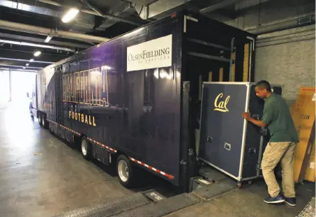  ?? Michael Macor / The Chronicle ?? Mover LaVaughn Ellis loads trunks full of equipment into a semi trailer at Memorial Stadium in Berkeley on Friday, the day before the Cal football team, and all of its gear, took off on a charter jet to Sydney for a game against Hawaii.