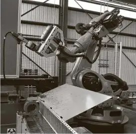  ?? Chris Tomlinson / Houston Chronicle ?? Rosie the Robot cleans, stencils and stacks pieces of pipe at Tube Supply Co. The company bought the robot to increase efficiency and reduce the risk of injury to workers. The robot will not replace any workers, the company says.