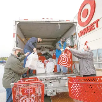  ?? DOUGLAS KILPATRICK/SPECIALTOT­HE MORNING CALL ?? Denny Fehr, left, of Pen Argyl, Charles Palmeri of Martins Creek, Francis Elchert of Pen Argyl, and Larry Hochreiter of Wind Gap load toys Saturday from the Lower Nazareth Township Target for kids at Lehigh Valley Reilly Children’s Hospital.