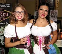  ?? Photo by Joseph B. Nadeau ?? Dalita Getzoyan and Hannah Duhamel help serve drinks at the Stadium Theatre’s annual Beerfest fundraiser, held Thursday.