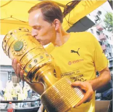 ?? — Reuters photo ?? Coach Thomas Tuchel of Borussia Dortmund celebrates with team German Soccer Cup Final victory v Frankfurt on their return to Dortmund, Germany in this May 28 file photo.