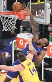  ?? Robert Gauthier Los Angeles Times ?? KAWHI LEONARD ( 26 points) draws one of the f ive fouls Marc Gasol was called for in the new starting Lakers center’s scoreless, one- rebound debut.