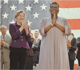  ??  ?? ON COURSE: U.S. Sen. Elizabeth Warren, left, applauds as Framingham Mayor Yvonne Spicer acknowledg­es the crowd after she was sworn in as the first mayor of the city of Framingham.