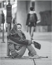  ??  ?? Tamara Loyer panhandles on Cordova street in Vancouver in 2014.