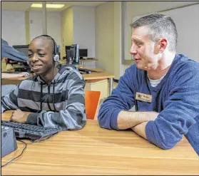  ??  ?? Mike Riley (right), a technology teacher at Lanier High in Sugar Hill, piloted the EarSketch program that teaches students to compose original music through coding. BILL BANKS FOR THE AJC