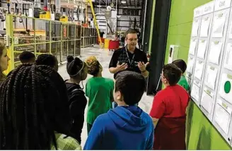  ?? THOMAS GNAU / STAFF ?? Bob Kinion, general manager of the Englewood Hematite plant, talks with students Friday from Englewood Hills Elementary. Hematite was one of more than 2,600 companies nationwide that opened their doors for Manufactur­ing Day.