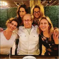  ?? Chevy Chase / Contribute­d photo ?? Chevy Chase and his wife, Jayni, enjoy dinner at The Wheel restaurant in Stamford with their daughters.