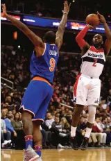  ??  ?? WASHINGTON: John Wall #2 of the Washington Wizards shoots in front of Kyle O’Quinn #9 of the New York Knicks during the second half at Verizon Center on Tuesday in Washington. — AFP