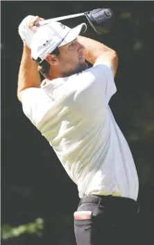  ?? ROB CARR/GETTY IMAGES ?? Scottie Scheffler drives from the ninth tee at the PGA’S Northern Trust on Friday, where he shot a round of 59. Scheffler enters the weekend trailing leader Dustin Johnson by two strokes.