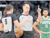  ?? JON DURR/AP ?? Referee John Goble and referee Natalie Sago (9) gesture during the second half of a game between the Bucks and the Celtics on Dec. 25 in Milwaukee.