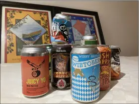  ?? CYRIL VIDERGAR — FOR THE TIMES-CALL ?? Regional craft brewers offer an assortment of beers by the can.