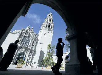  ?? AP PHOTO/GREGORY BULL ?? A boy walks past a building in Balboa Park in San Diego. Balboa Park which marked its 100th anniversar­y in 2015, is a 1,200-acre urban oasis that rivals New York’s Central Park and is home to the San Diego Zoo.