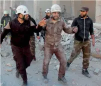  ?? AFP file ?? Members of The White Helmets react after a strike during a rescue operation in the town of Binnish, near Idlib, in Syria. —