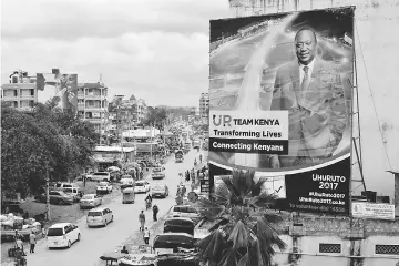  ??  ?? A billboard depicts Kenyatta ahead of the presidenti­al election in Mombasa.— Reuters photo