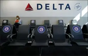  ?? ASSOCIATED PRESS FILE PHOTO ?? A passenger wears a face mask as she waits in a socially-distance area for a Delta Airlines flight at Hartsfield-Jackson Internatio­nal Airport in Atlanta.