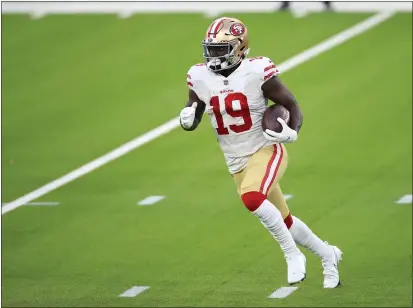  ?? PHOTOS BY JOE SCARNICI — GETTY IMAGES ?? San Francisco 49ers wide receiver Deebo Samuel runs with the ball during the second half against the Los Angeles Rams at SoFi Stadium on Sunday in Inglewood.