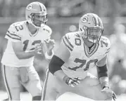  ?? Jeff Haynes / Associated Press ?? Protecting Green Bay quarterbac­k Aaron Rodgers for as long as possible can be a challengin­g task for guard T.J. Lang (70) and the Packers’ offensive line, where success often is measured in seconds.