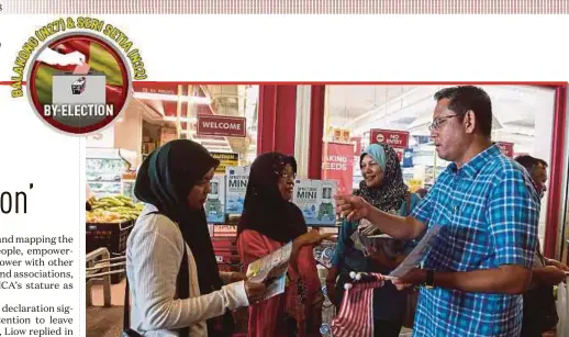  ?? BERNAMA PIC ?? Pakatan Harapan candidate for the Seri Setia by-election Halimey Abu Bakar (right) speaking to residents outside a supermarke­t in Kelana Jaya yesterday.