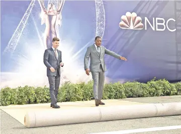  ??  ?? Presenters Colin Jost and Michael Che roll out the gold carpet for the 70th Emmy Awards at Microsoft Theater on Thursday in Los Angeles, California. — AFP photo