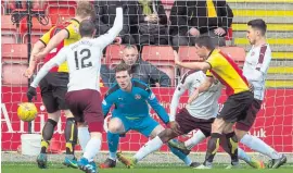  ??  ?? Kris Doolan tucks home the first for Thistle