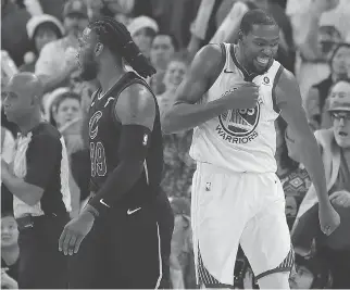  ?? TONY AVELAR/THE ASSOCIATED PRESS ?? Warriors forward Kevin Durant, right, blocked a key late shot by LeBron James and celebrated in front of Cleveland’s Jae Crowder during Golden State’s victory Monday in Oakland.