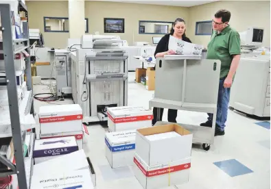  ??  ?? Bill Lewis and Rosie Rivera work at CMS Mailing in Monroe, Conn. Lewis was hired through a nonprofit group that pays the salaries of some new hires for their first eight weeks on the job.