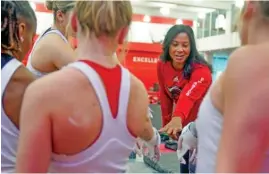  ?? AP PHOTO/SETH WENIG ?? Rutgers women’s gymnastics coach Umme Salim-Beasley joins a huddle during a practice March 2 at Rutgers in Piscataway, N.J.