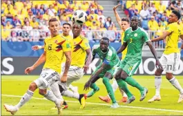  ??  ?? Colombia's midfielder Mateus Uribe (L) eyes the ball watched by Senegal players on Thursday.