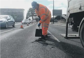  ??  ?? A worker filling potholes on Wearmouth Bridge in Sunderland.