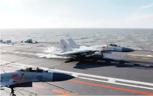  ??  ?? BEIJING: A Chinese J-15 fighter jet landing on the deck of the Liaoning aircraft carrier during military drills in the Bohai Sea, off China’s northeast coast. —AFP